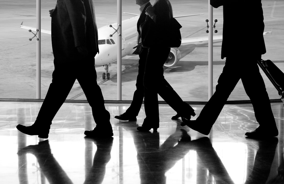 Business travelers walking through an airport terminal