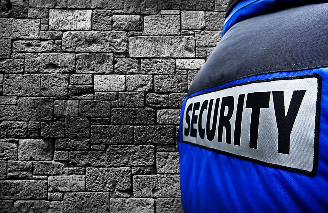 Close-up of a security jacket against a stone wall